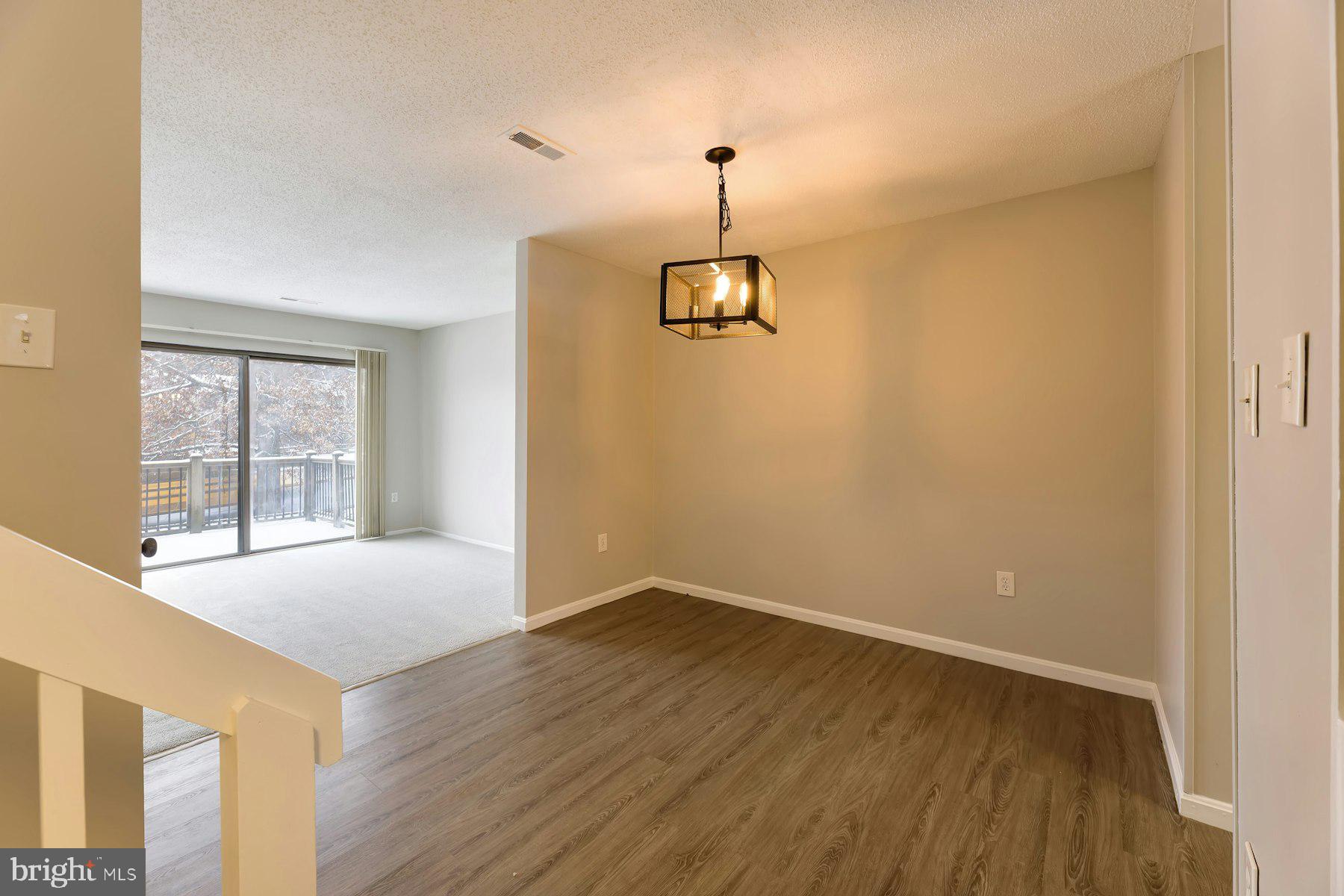 2105 Old Landing Way Woodbridge, VA 22191 - Photo 6 of 30 a view of an empty room with a window and wooden floor