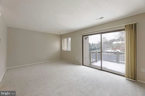 a view of an empty room with windows