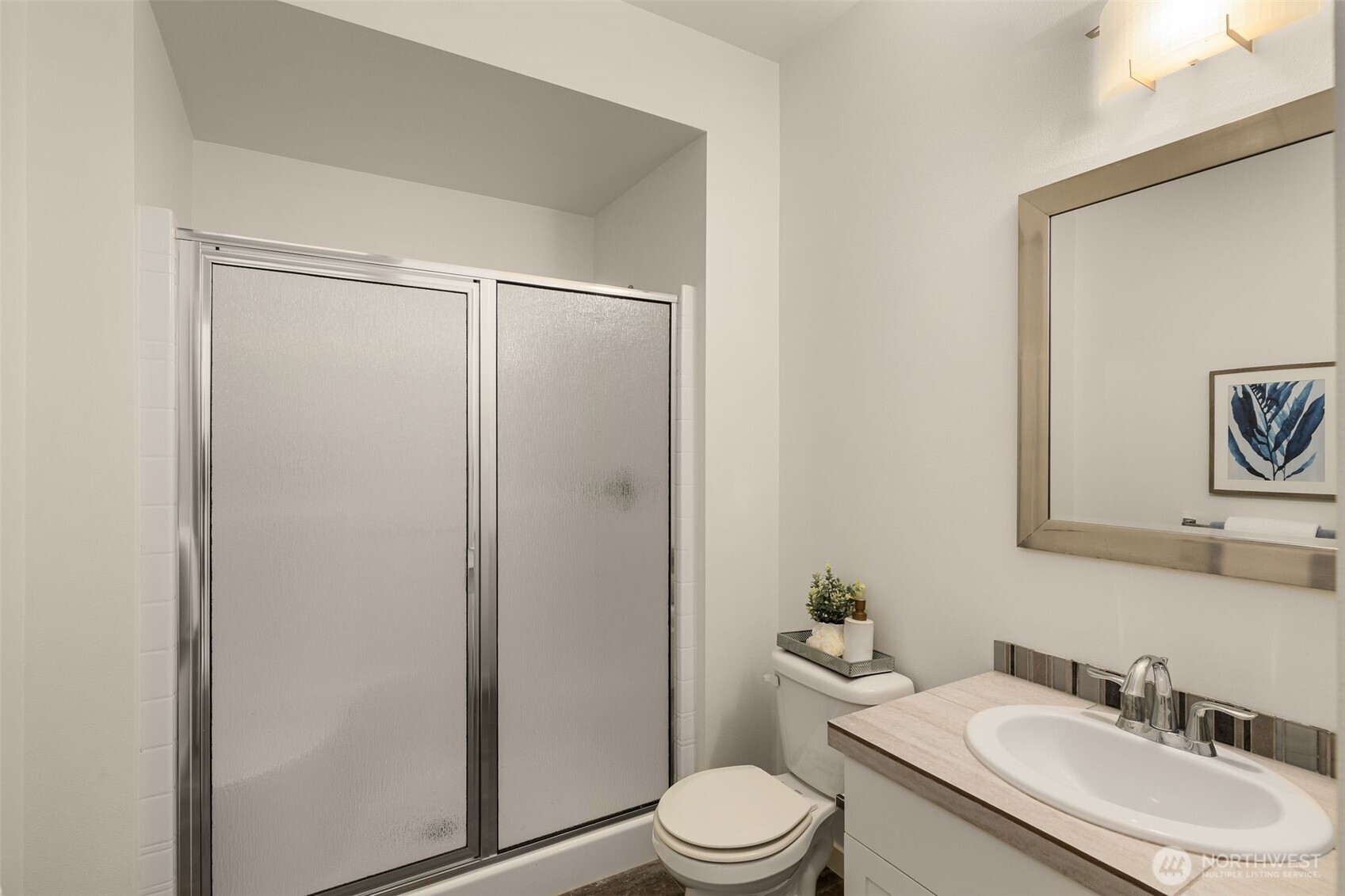 24 174th Place Southwest Bothell, WA 98012 - Photo 23 of 33 a bathroom with a granite countertop sink toilet a mirror and shower