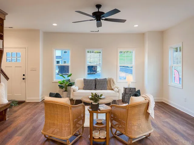 a living room with furniture and wooden floor