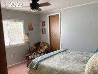 1267 Tucker Road, Unit 8 Hood River, OR 97031 - Photo 15 of 21 a bedroom with a bed and a window