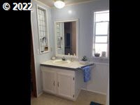 1267 Tucker Road, Unit 8 Hood River, OR 97031 - Photo 16 of 21 a bathroom with a granite countertop sink and a mirror