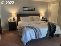 1267 Tucker Road, Unit 8 Hood River, OR 97031 - Photo 17 of 21 a bedroom with a bed and a view of bathroom