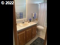 1267 Tucker Road, Unit 8 Hood River, OR 97031 - Photo 19 of 21 a bathroom with a sink and a mirror