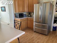 1267 Tucker Road, Unit 8 Hood River, OR 97031 - Photo 7 of 21 a kitchen with appliances and cabinets