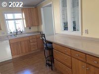 1267 Tucker Road, Unit 8 Hood River, OR 97031 - Photo 8 of 21 a kitchen with a sink a window and cabinets