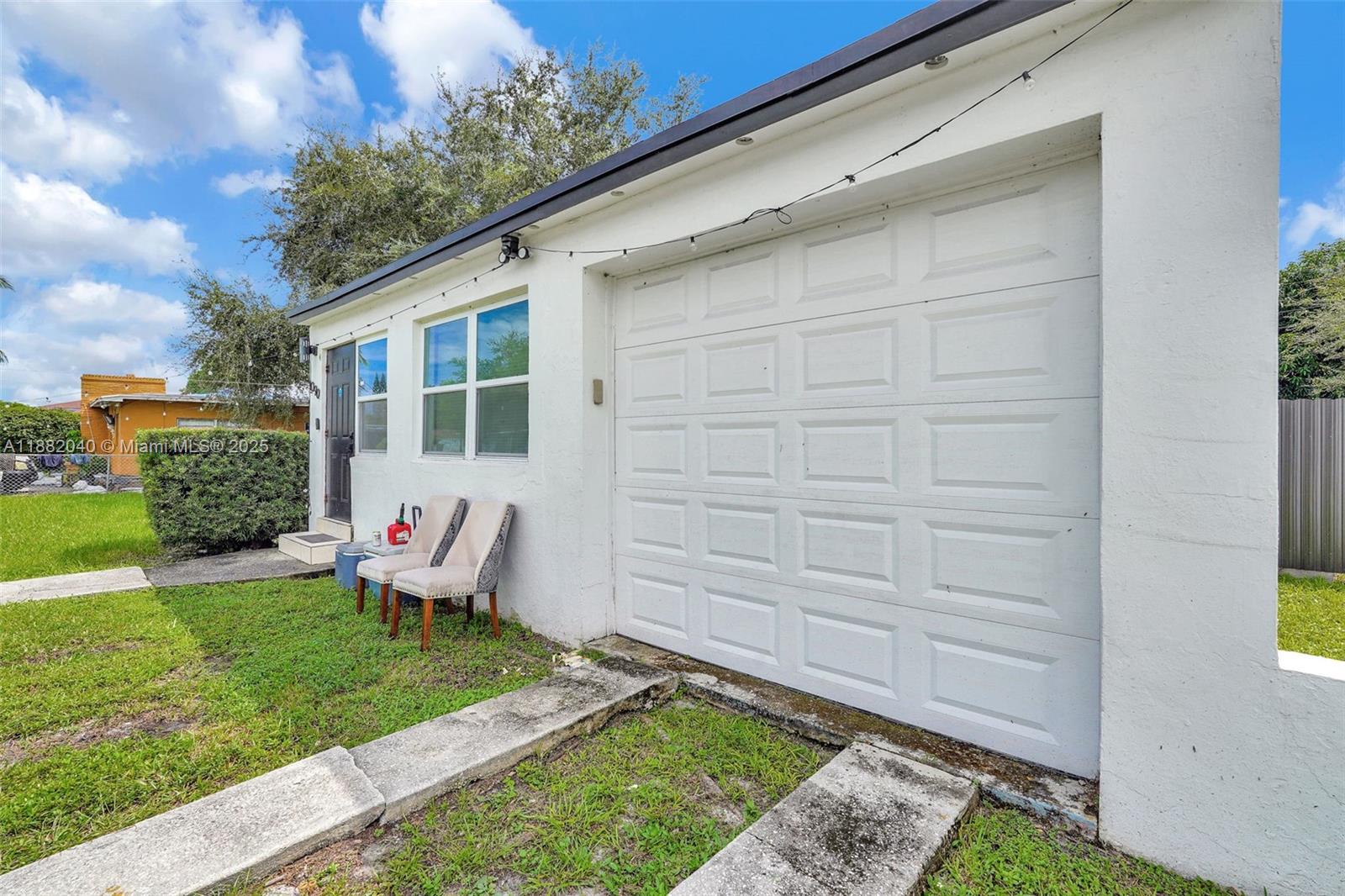 1090 Northwest 77th Street Miami, FL 33150 - Photo 11 of 77 a view of a backyard with table and chairs and wooden fence