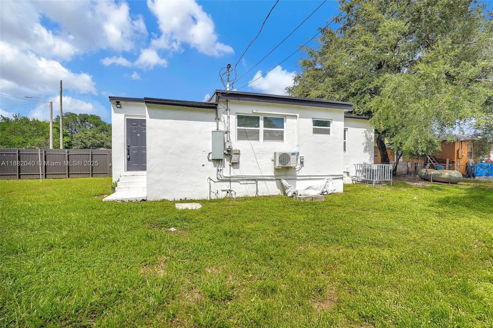1090 Northwest 77th Street Miami, FL 33150 - Photo 17 of 77 a view of backyard of house with outdoor seating and green space