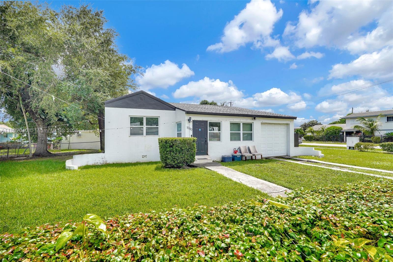 1090 Northwest 77th Street Miami, FL 33150 - Photo 2 of 77 a front view of a house with garden