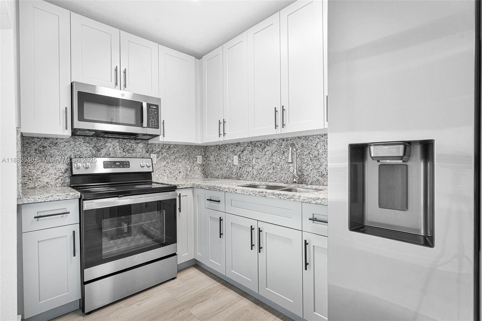 1090 Northwest 77th Street Miami, FL 33150 - Photo 25 of 77 a kitchen with stainless steel appliances granite countertop a stove microwave and cabinets