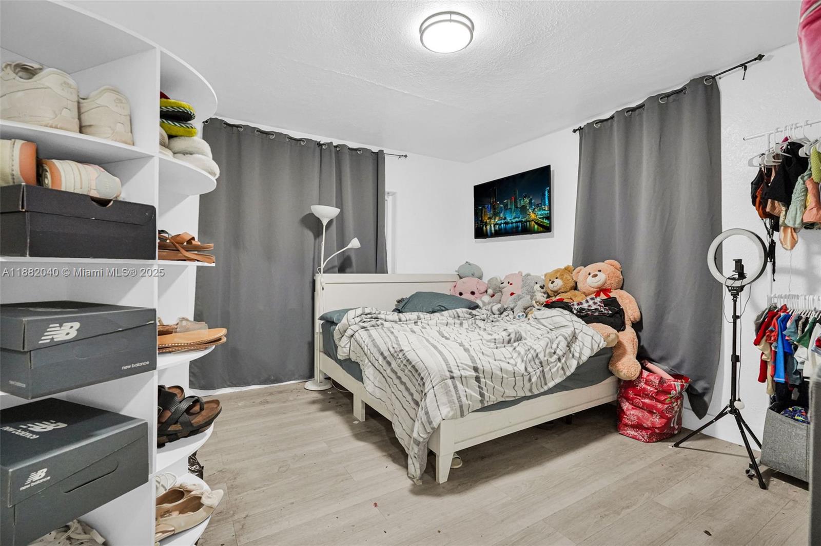 1090 Northwest 77th Street Miami, FL 33150 - Photo 28 of 77 a bedroom with a bed and a tv