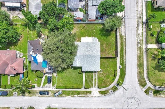 an aerial view of a house with garden space and outdoor seating