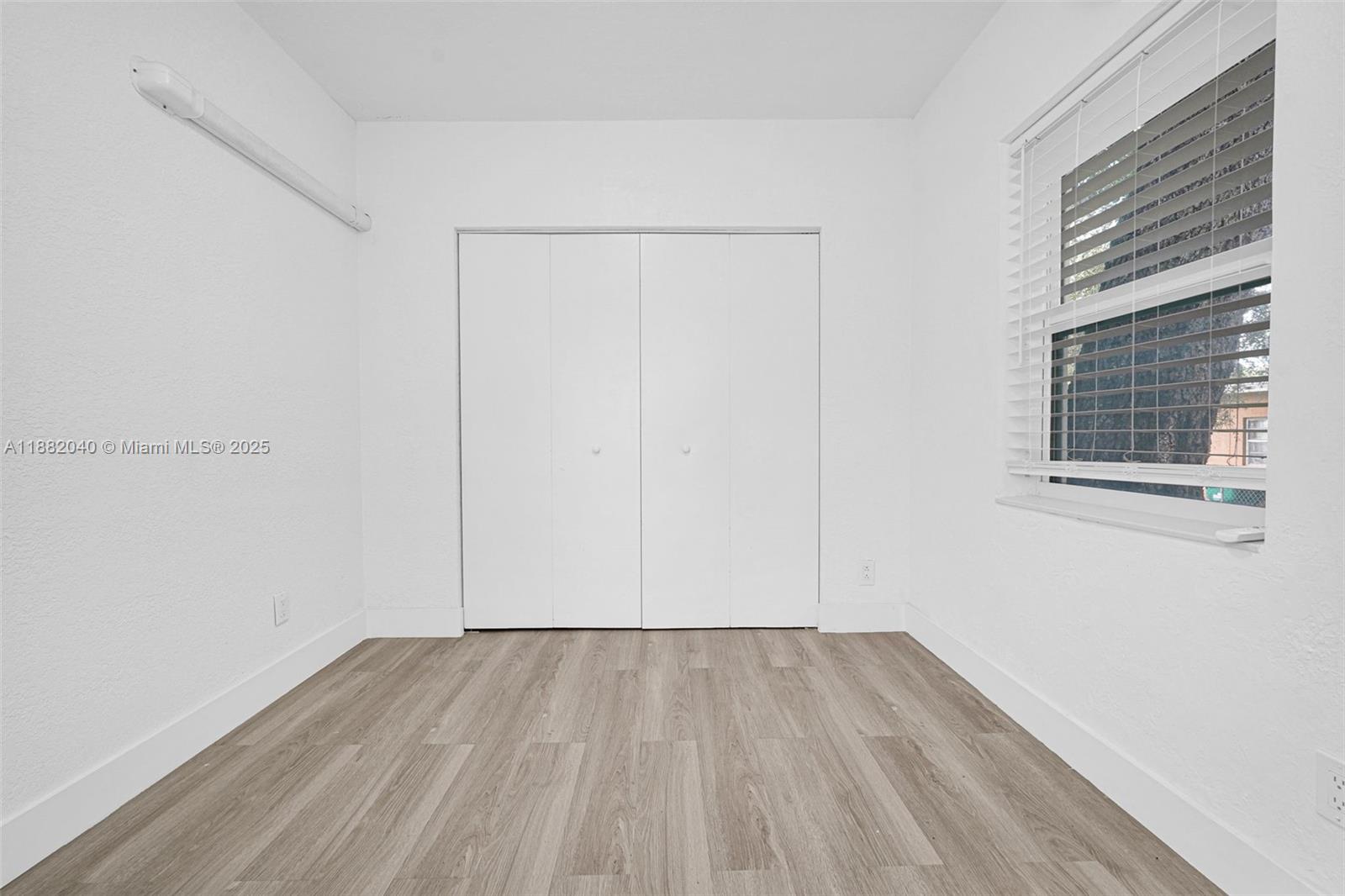 1090 Northwest 77th Street Miami, FL 33150 - Photo 40 of 77 a view of a room with wooden floor and windows