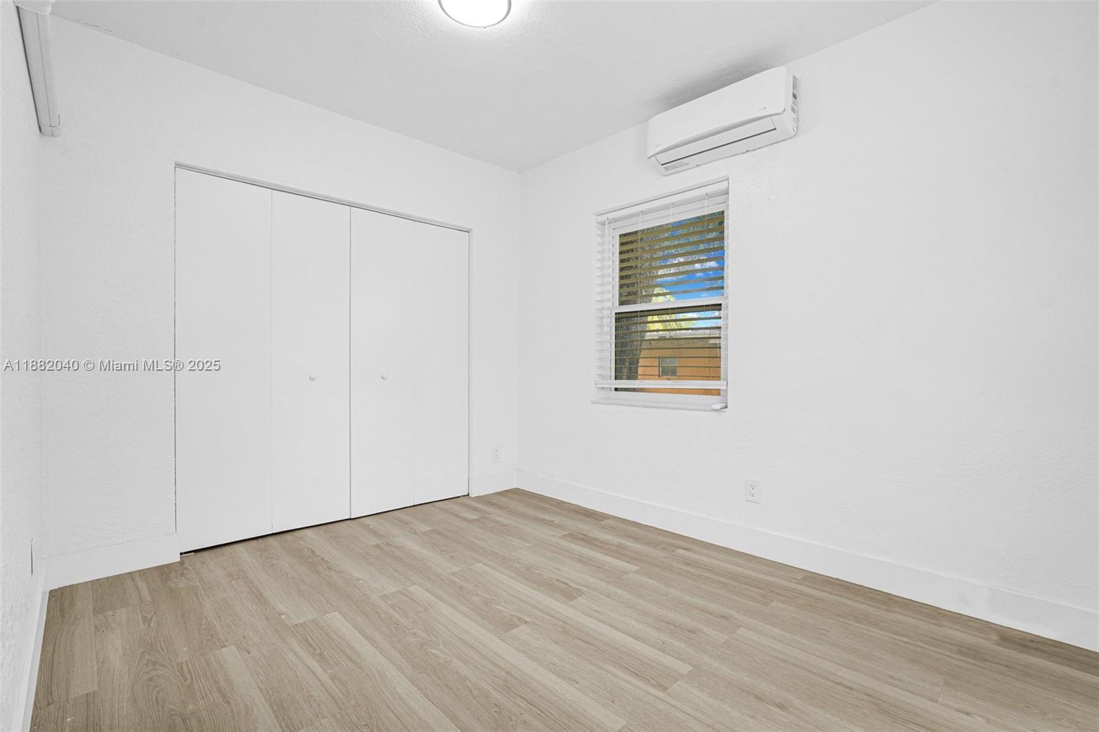 1090 Northwest 77th Street Miami, FL 33150 - Photo 58 of 77 an empty room with wooden floor and windows