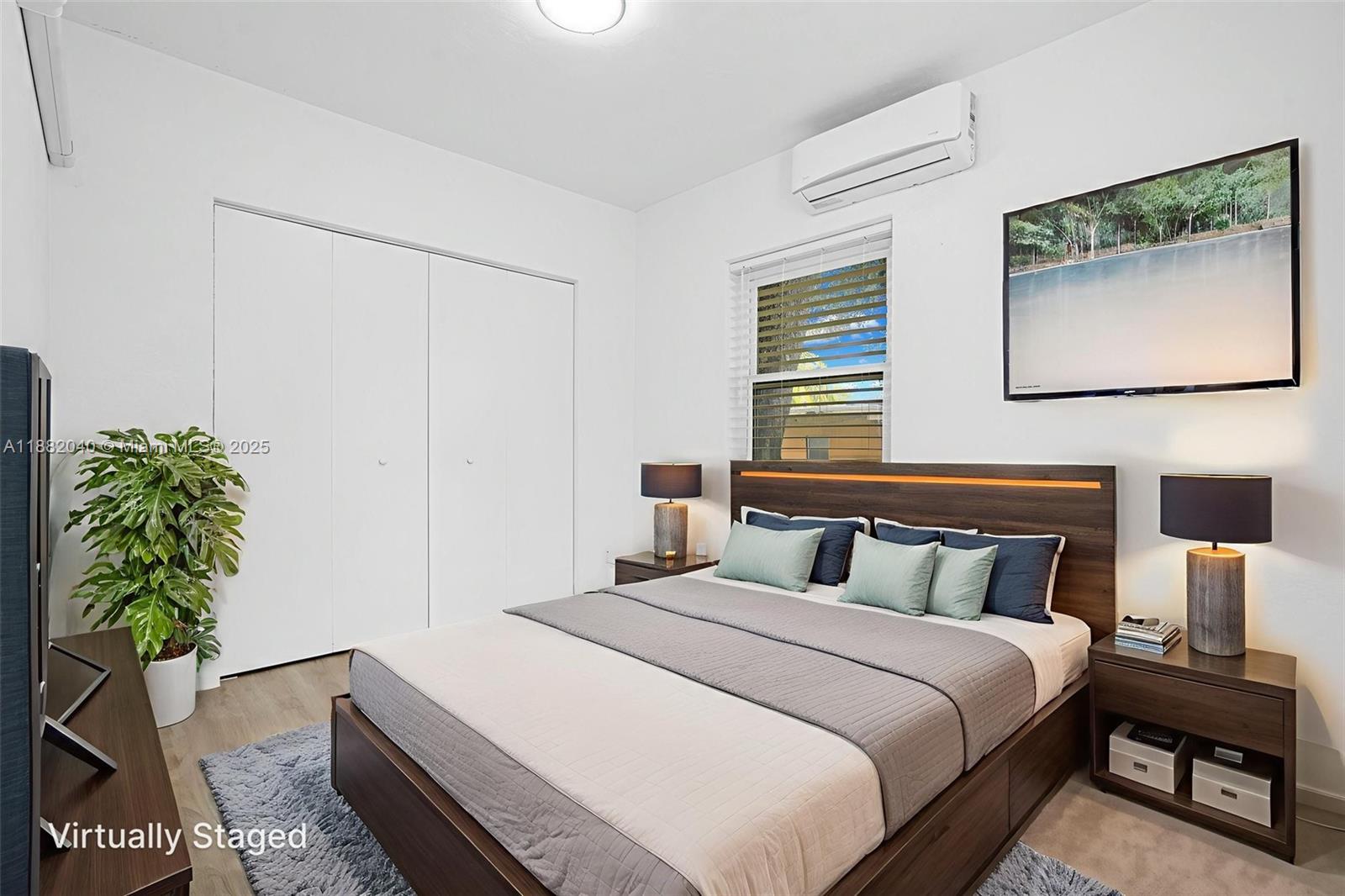 1090 Northwest 77th Street Miami, FL 33150 - Photo 59 of 77 a bedroom with a bed a dresser and a potted plant