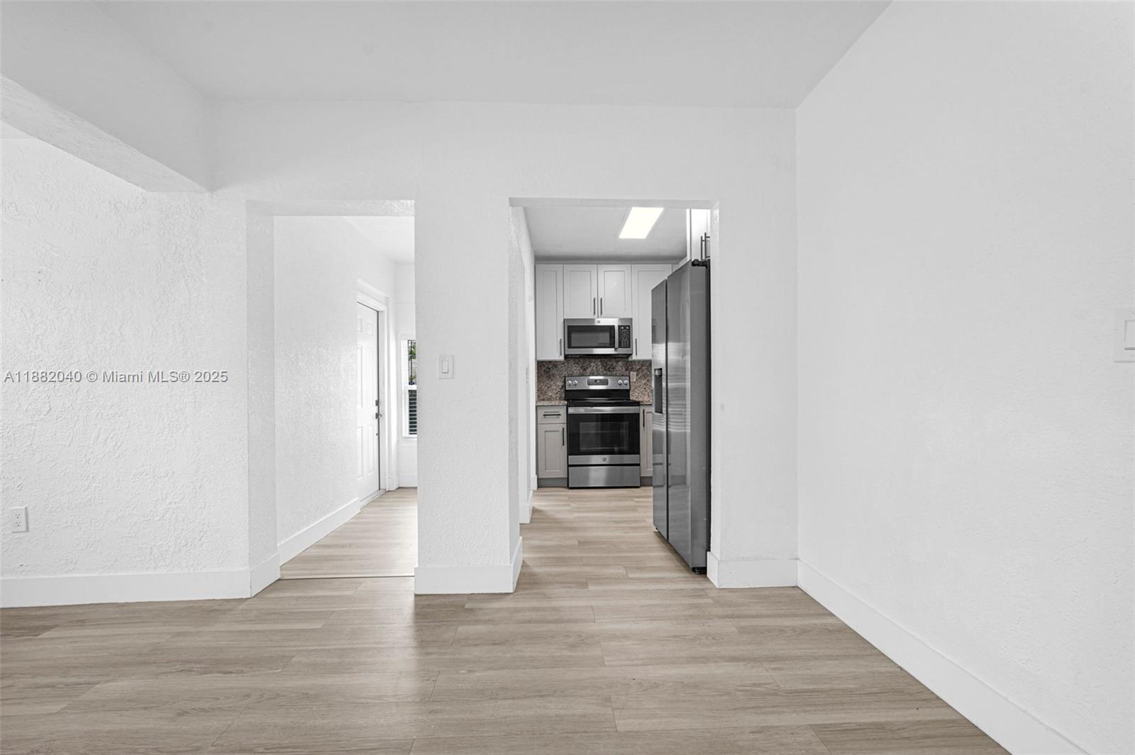 1090 Northwest 77th Street Miami, FL 33150 - Photo 60 of 77 a view of a kitchen with wooden floor and a refrigerator