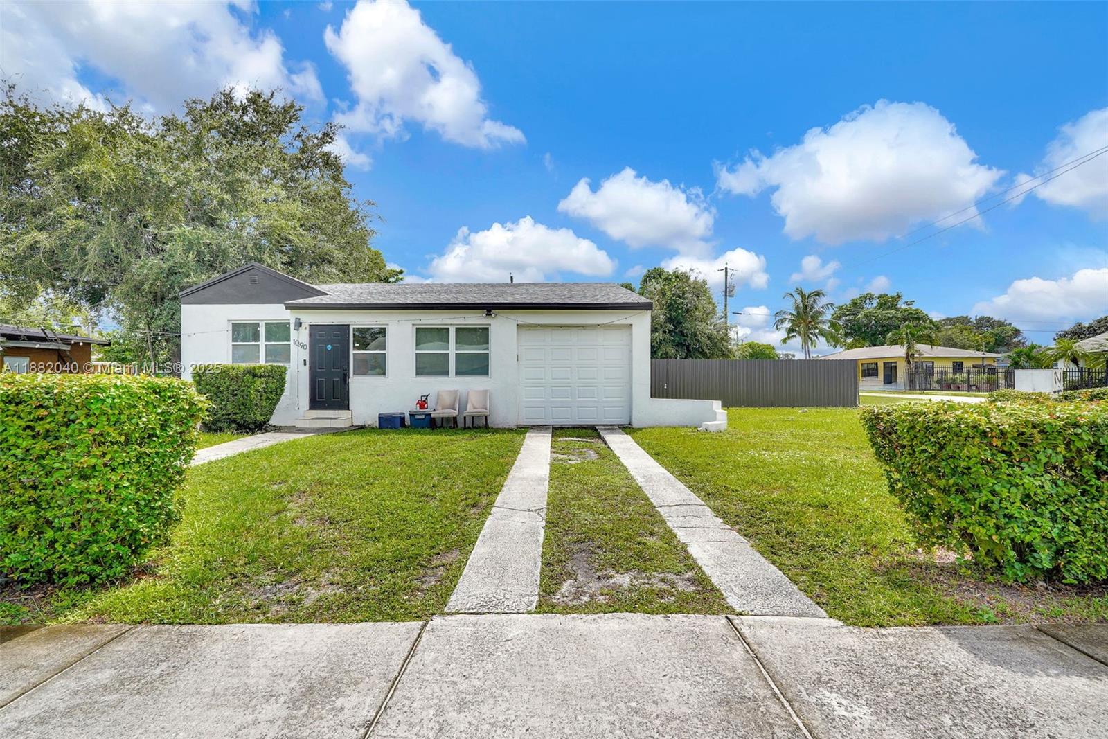 1090 Northwest 77th Street Miami, FL 33150 - Photo 7 of 77 front view of house with a yard