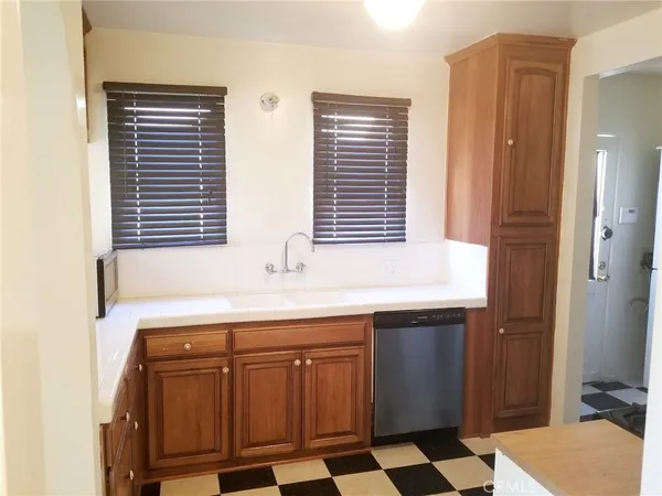 a kitchen with a sink a window and cabinets