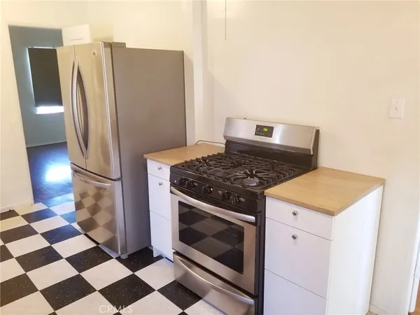 a kitchen with a stove and a refrigerator