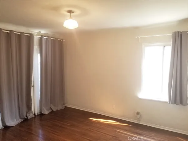 a view of a room with wooden floor and fan