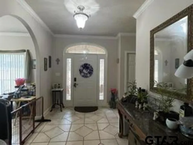 a view of a dining room with furniture and chandelier