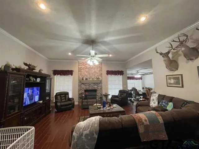 a living room with furniture a flat screen tv and a fireplace