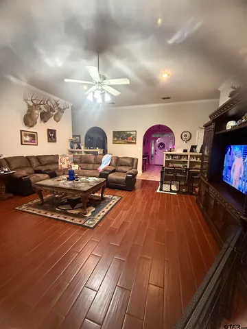 a living room with furniture and a flat screen tv