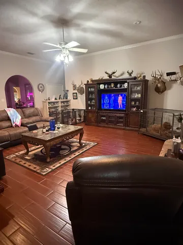 a living room with furniture a rug and a flat screen tv