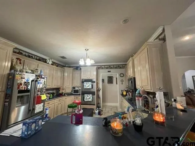 a kitchen with sink refrigerator and cabinets