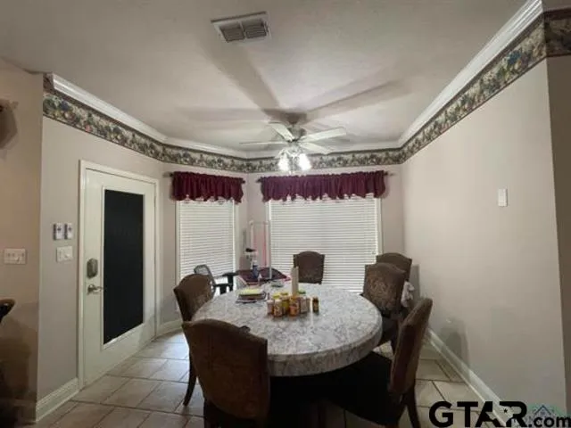 a view of a dining room with furniture and chandelier