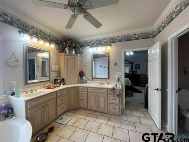 a spacious bathroom with a double vanity sink a mirror and a bathtub