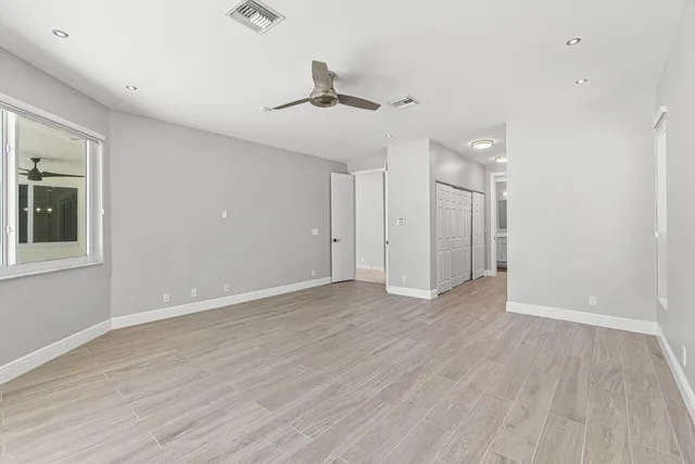 a view of walk in closet with empty racks