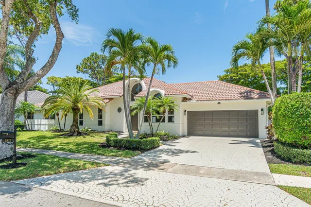 a front view of house with yard and green space