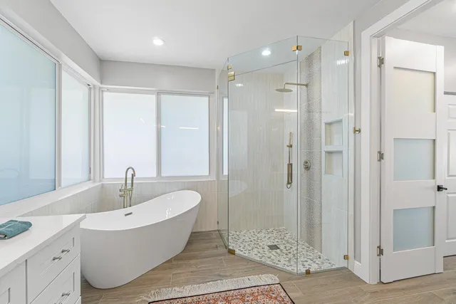 a bathroom with a bathtub and shower