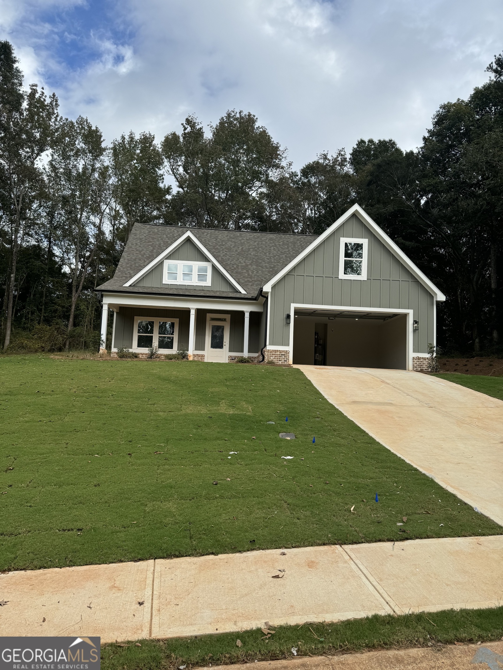 63 Delightful Way, Unit 1 Winder, GA 30680 - Photo 1 of 26 a front view of a house with a garden