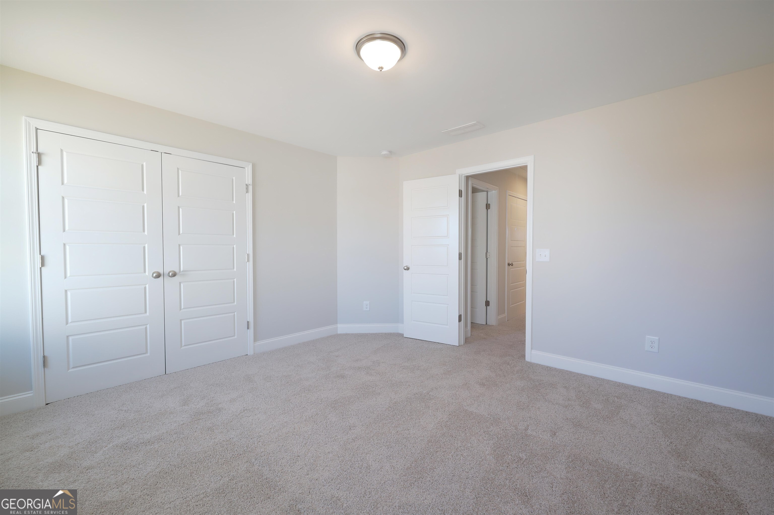 63 Delightful Way, Unit 1 Winder, GA 30680 - Photo 18 of 26 an empty room with closet area and bathroom