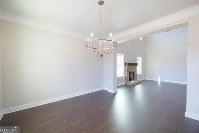 a view of a room with wooden floor and a window