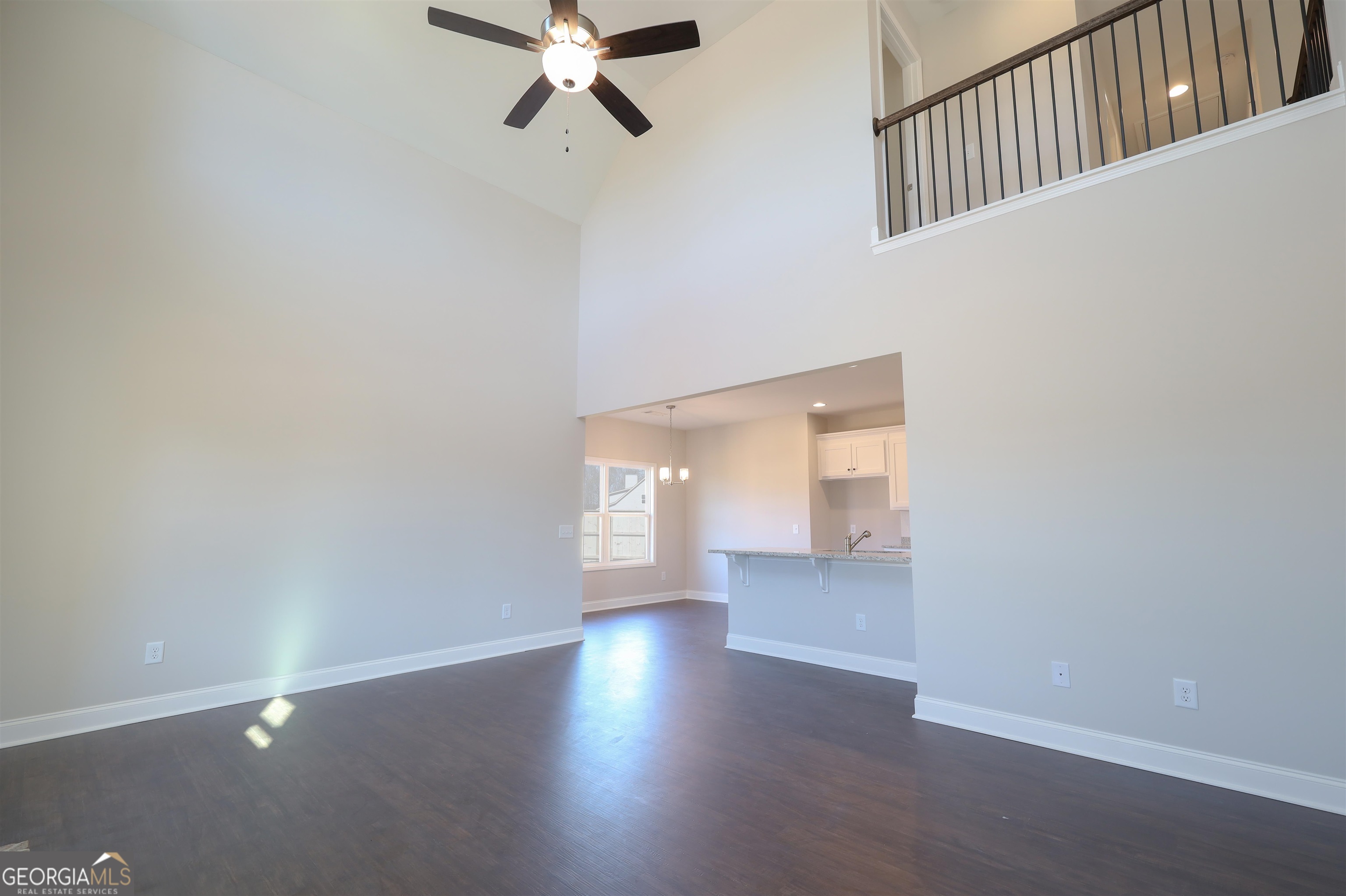 63 Delightful Way, Unit 1 Winder, GA 30680 - Photo 7 of 26 a view of an empty room with wooden floor and a window