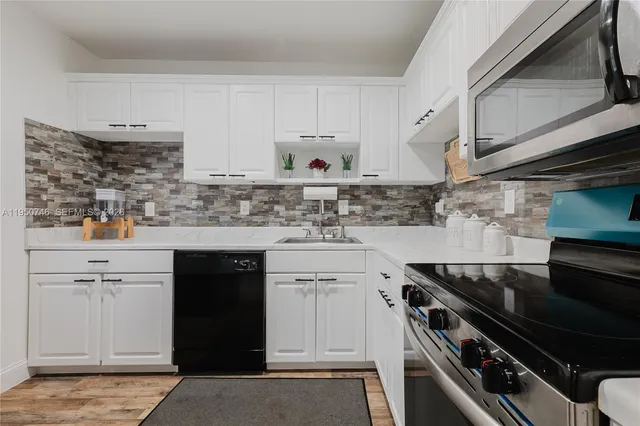 a kitchen with stainless steel appliances a stove and cabinets