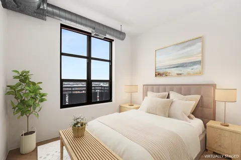 a bedroom with a bed and a potted plant
