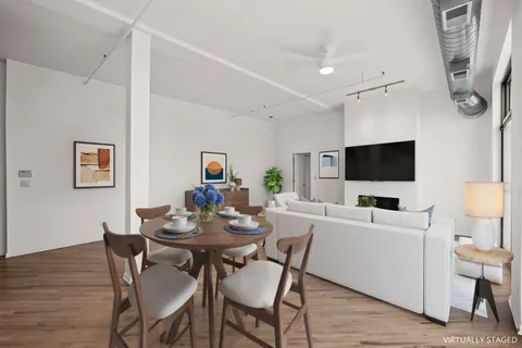 a view of a dining room with furniture and wooden floor