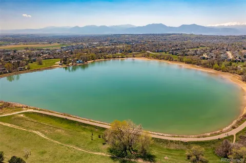 a front view of multi story residential apartment building with yard and green space