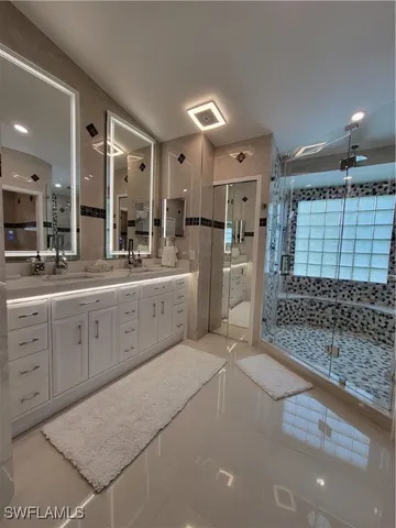 a large white kitchen with cabinets