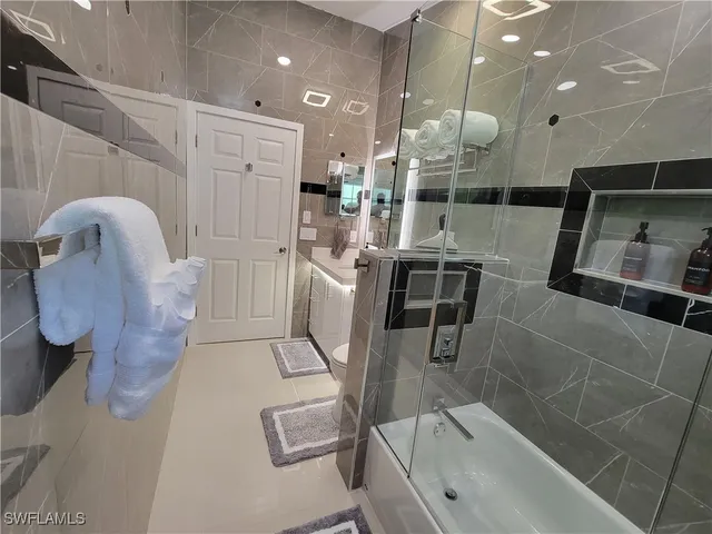 a kitchen with stainless steel appliances kitchen island granite countertop a sink and cabinets