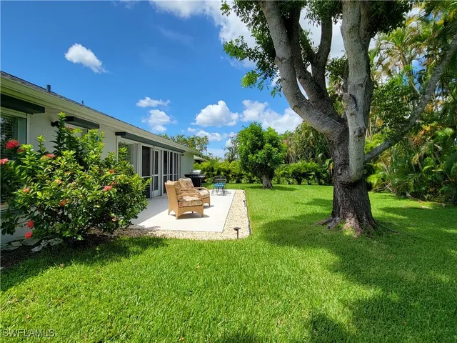 a view of a house with backyard porch and sitting area