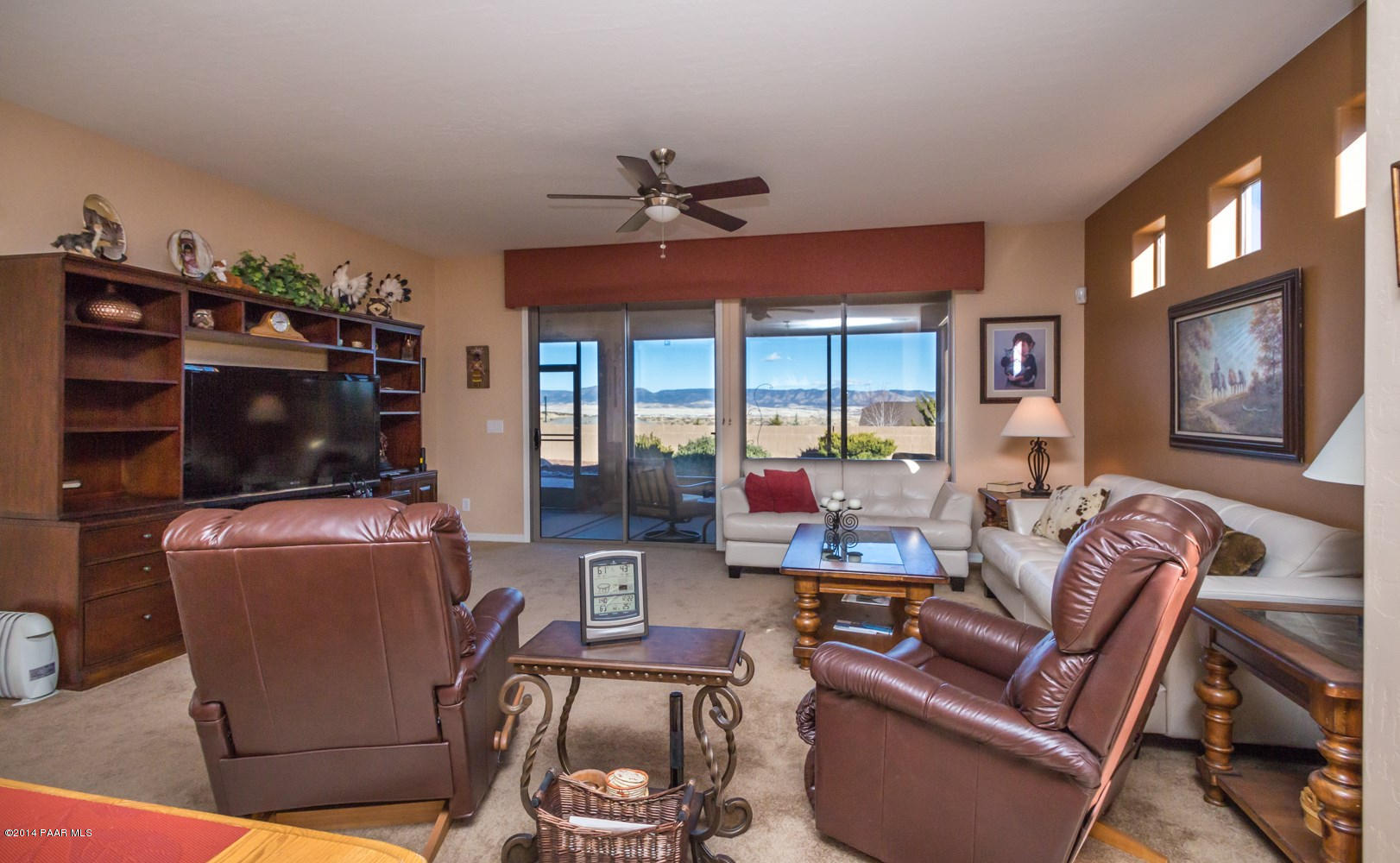 1229 Rusty Nail Road Prescott Valley, AZ 86314 - Photo 4 of 25 a living room with furniture a flat screen tv and a fireplace