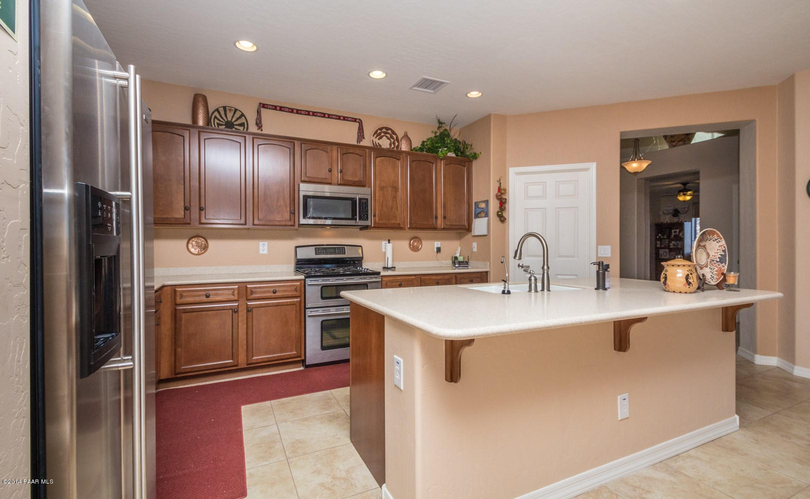 1229 Rusty Nail Road Prescott Valley, AZ 86314 - Photo 8 of 25 a kitchen with stainless steel appliances granite countertop a sink stove and refrigerator
