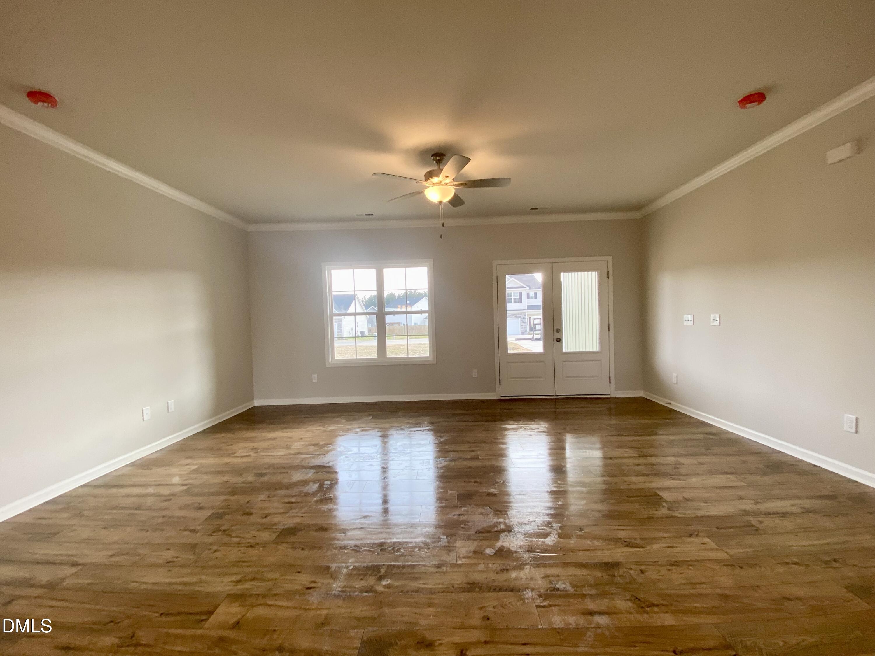 155 Nectar Lane Bunnlevel, NC 28323 - Photo 6 of 16 a view of an empty room with window and wooden floor