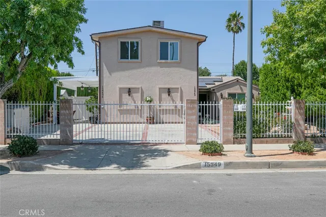a front view of a house with a garden and plants
