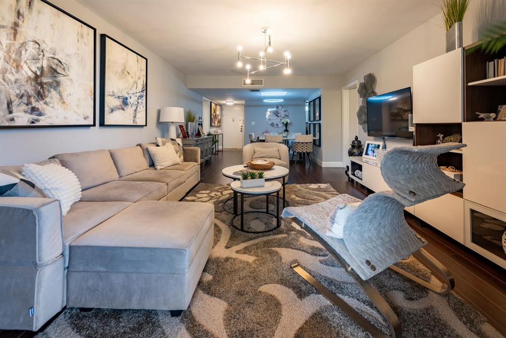 16251 Golf Club Road, Unit 305 Weston, FL 33326 - Photo 17 of 43 a living room with furniture and a chandelier